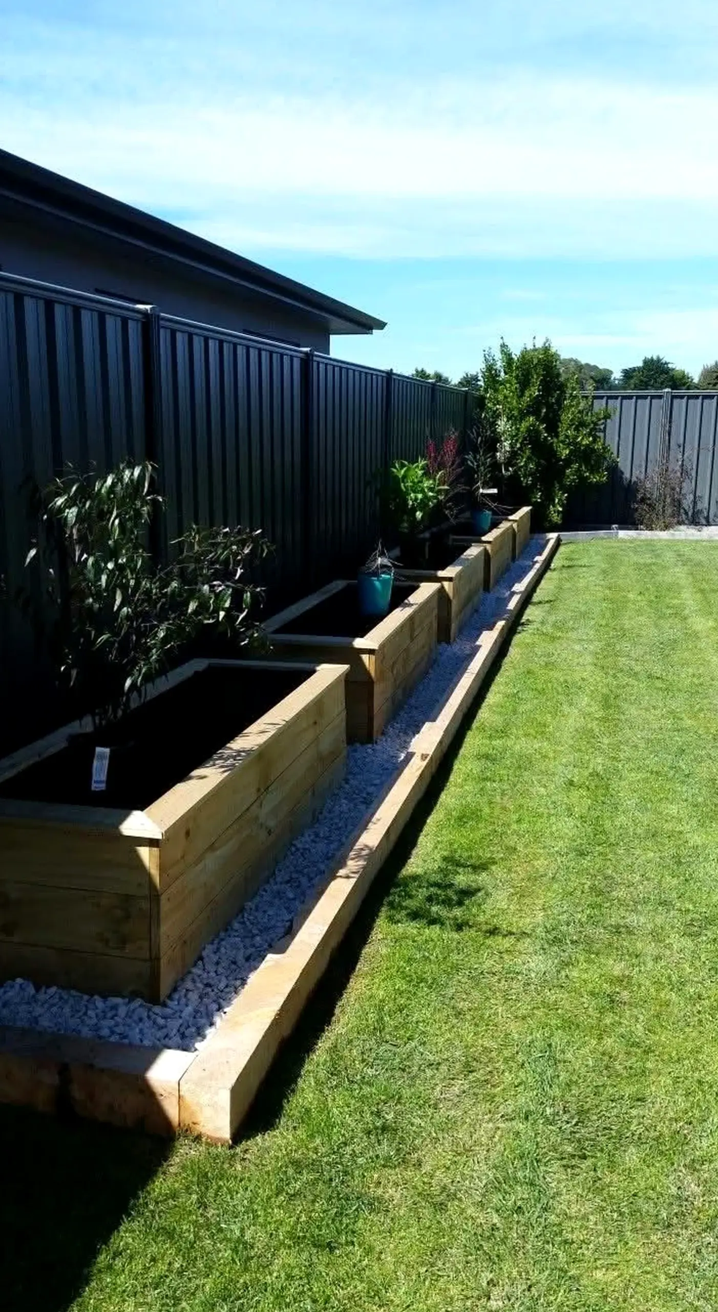 Polished garden border gives the corner more warmth, so the whole view feels fresh and intentional.